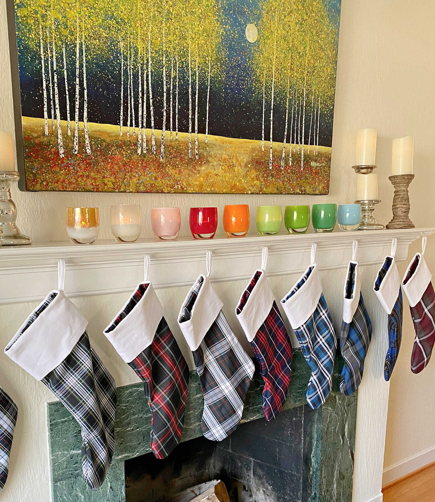 School Plaid holiday stockings hanging from a living room mantle