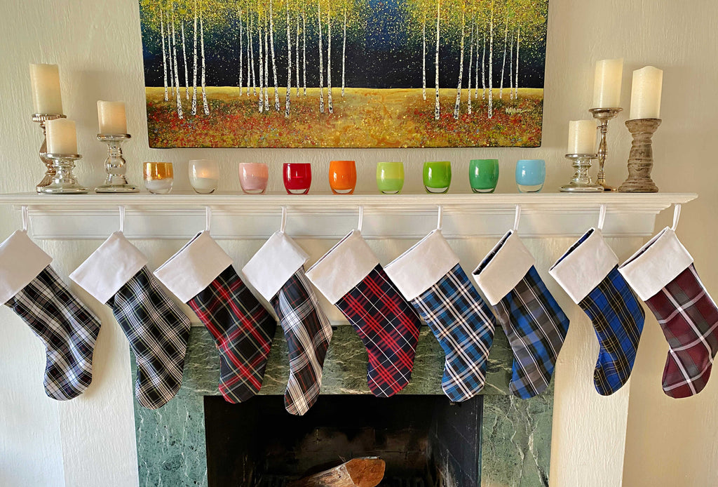 School Plaid holiday stockings hanging from a living room mantle
