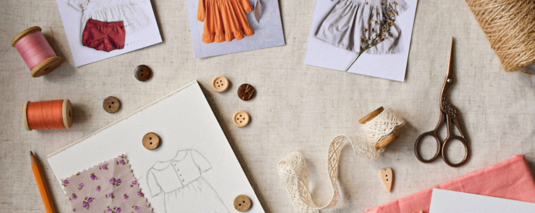 Photo of fashion sketches and sewing supplies on tabletop