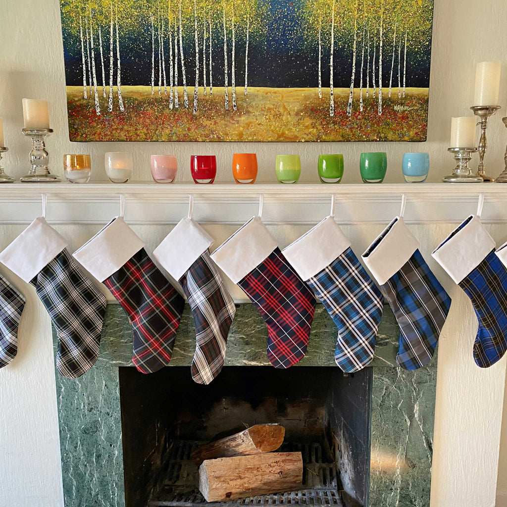 School Plaid holiday stockings hanging from a living room mantle